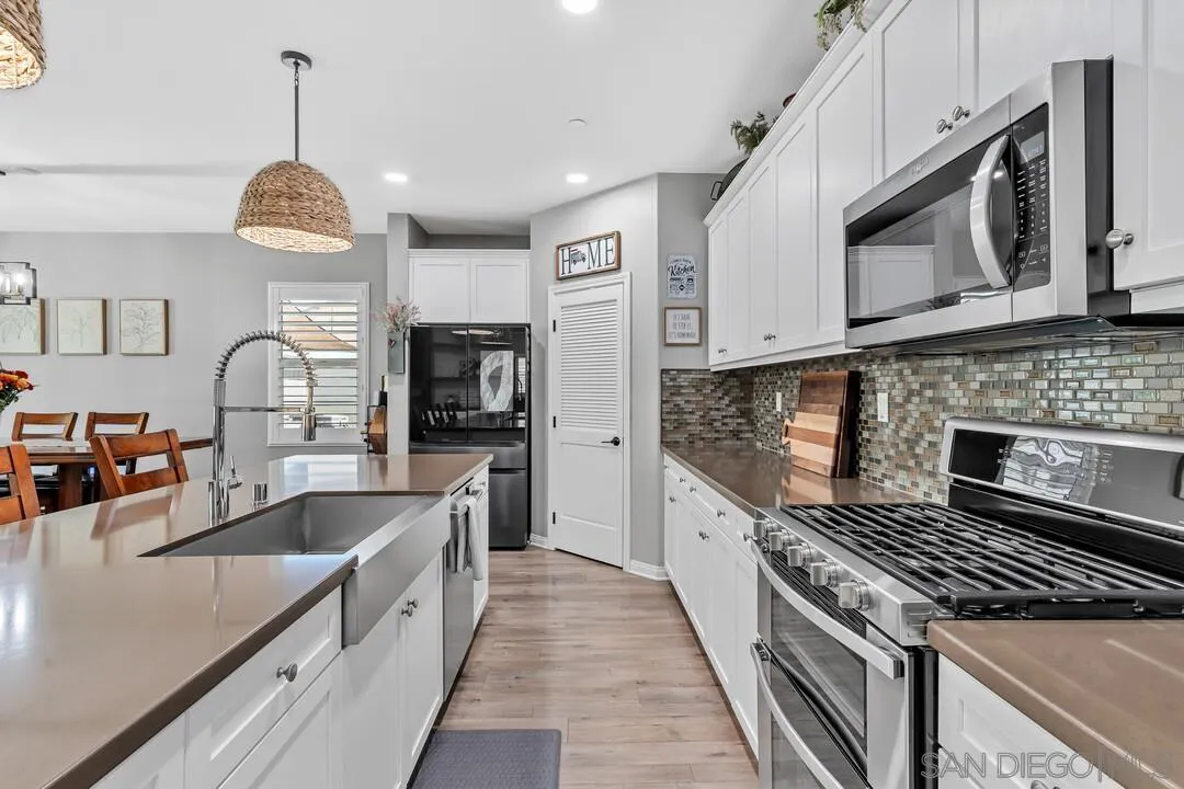 10700 Spring Creek Drive Santee, CA 92071 - Photo 16 of 74 a large kitchen with stainless steel appliances granite countertop a stove and a sink