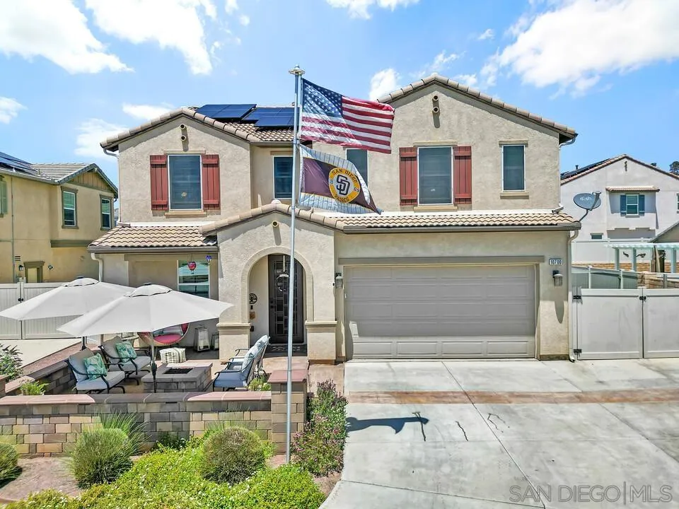 10700 Spring Creek Drive Santee, CA 92071 - Photo 2 of 74 a front view of a house with a yard and garage