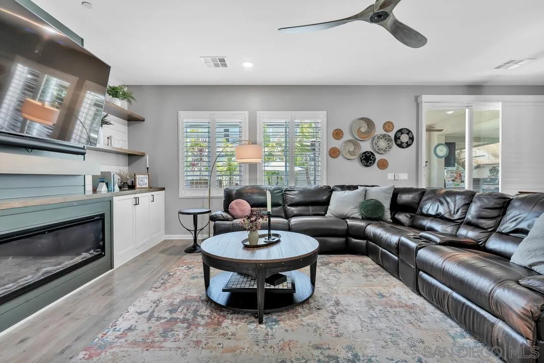10700 Spring Creek Drive Santee, CA 92071 - Photo 22 of 74 a living room with fireplace furniture and a large window