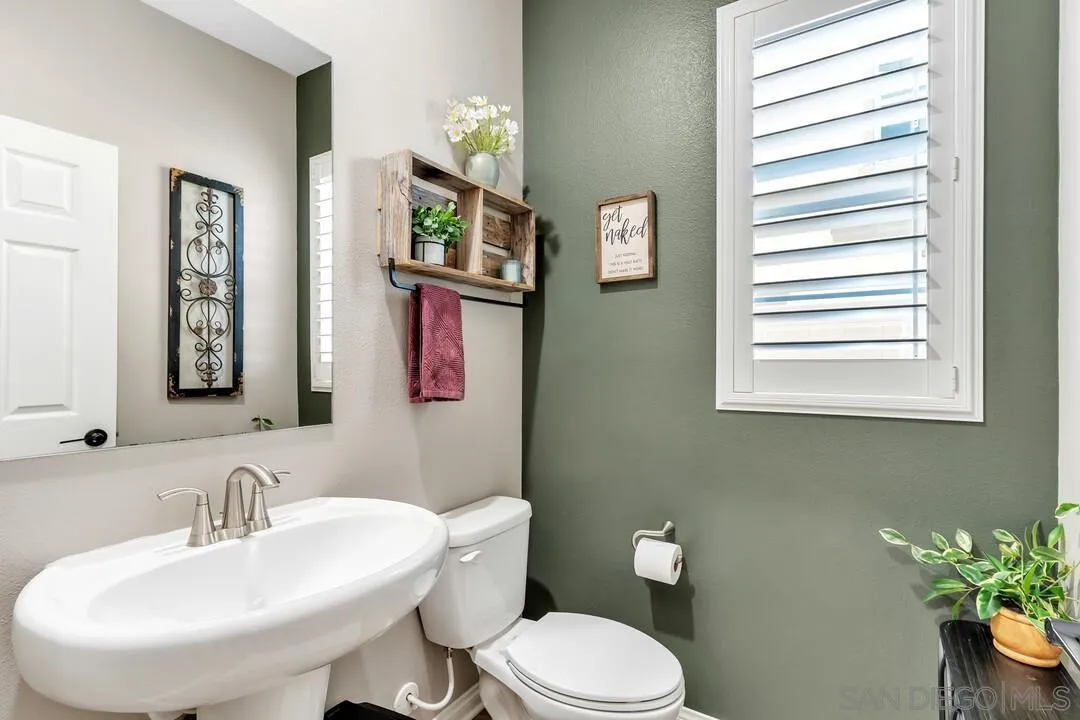 10700 Spring Creek Drive Santee, CA 92071 - Photo 27 of 74 a bathroom with a toilet a sink and a mirror