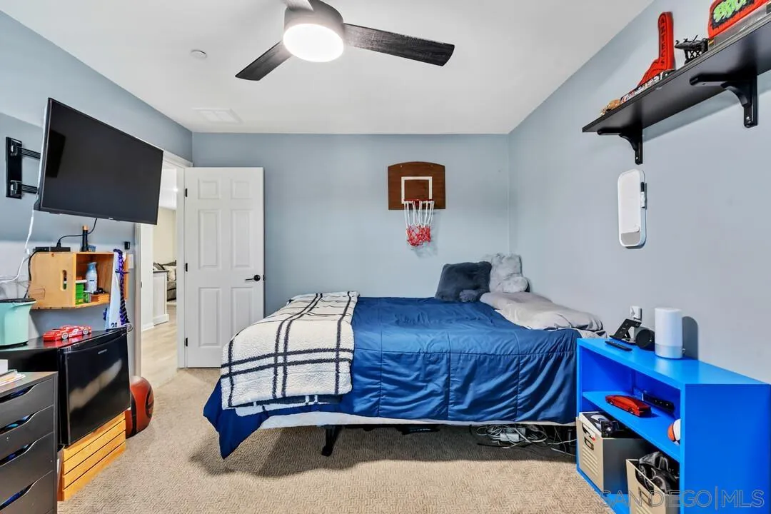 10700 Spring Creek Drive Santee, CA 92071 - Photo 46 of 74 a bedroom with furniture and a flat screen tv