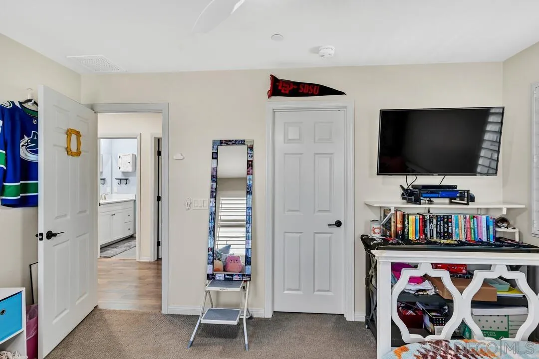 10700 Spring Creek Drive Santee, CA 92071 - Photo 49 of 74 a living room with furniture and a flat screen tv