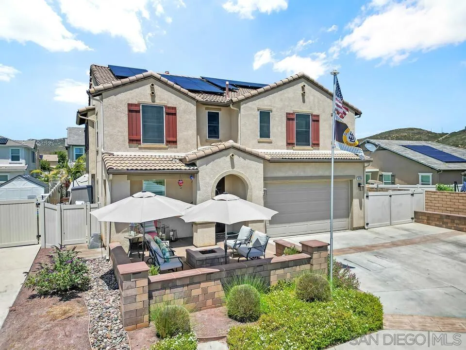 10700 Spring Creek Drive Santee, CA 92071 - Photo 5 of 74 a view of a white house with a yard and furniture