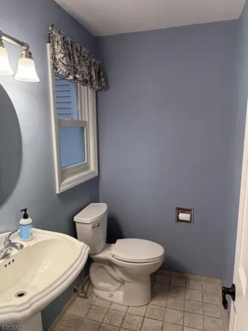 a white toilet sitting next to a bathroom sink