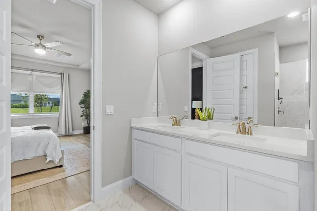 a en suite bathroom with double sink and a mirror