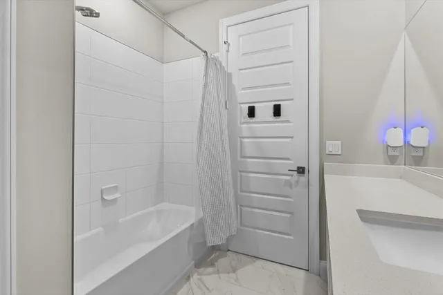 a bathroom with a bathtub and a shower