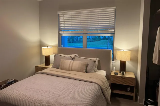 a bedroom with a bed and a night stand