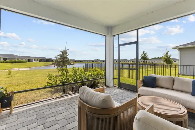 a living room with furniture and a floor to ceiling window