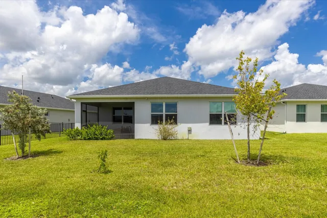 a front view of a house with a garden and yard