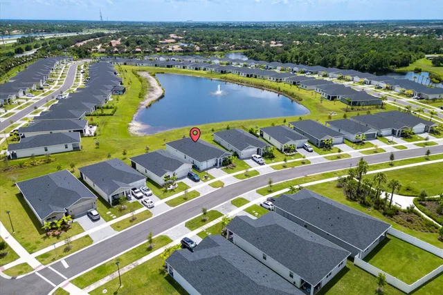 an aerial view of a house with a lake view