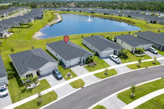 an aerial view of a house with a swimming pool yard and outdoor seating