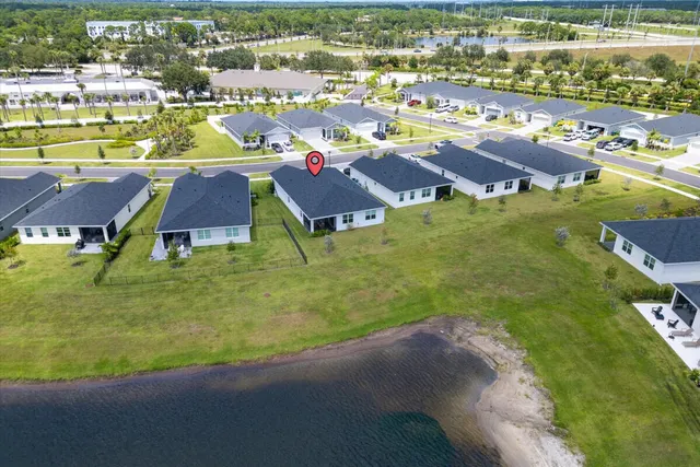 an aerial view of residential houses with outdoor space and swimming pool