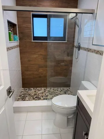 a bathroom with a toilet and a shower