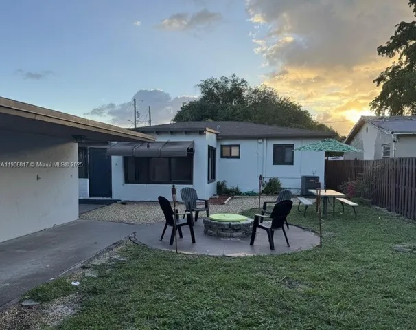 a view of a house with patio and a yard