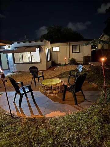 a view of a porch with chairs and backyard