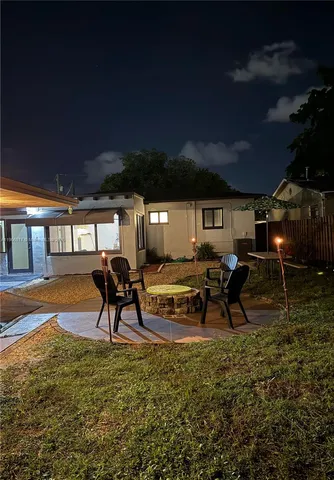 a swimming pool with outdoor seating and yard