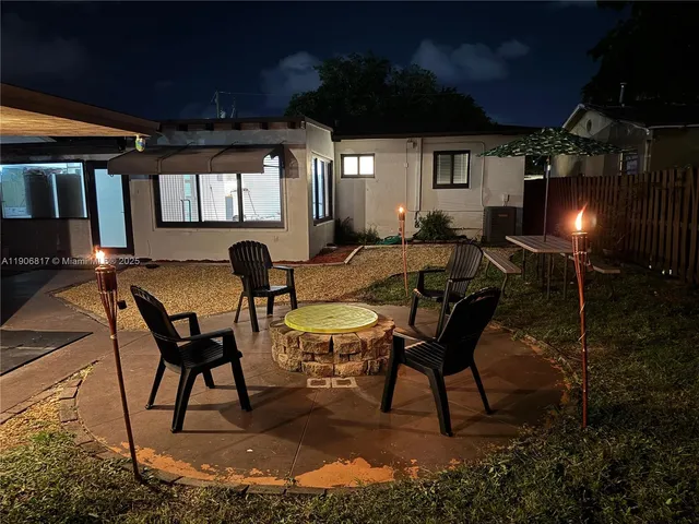 a view of a porch with furniture and chandelier