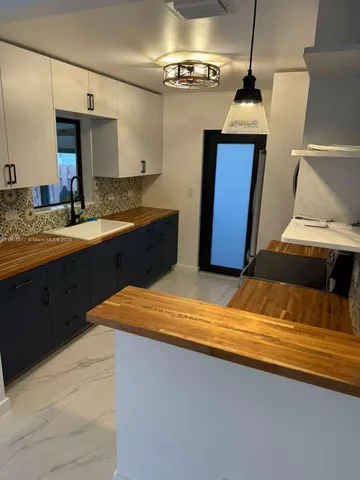 a bedroom with a sink and a mirror