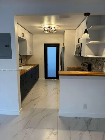 a bathroom with a sink and a large mirror