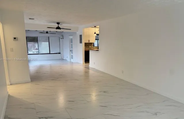 a view of a kitchen with a sink and a refrigerator