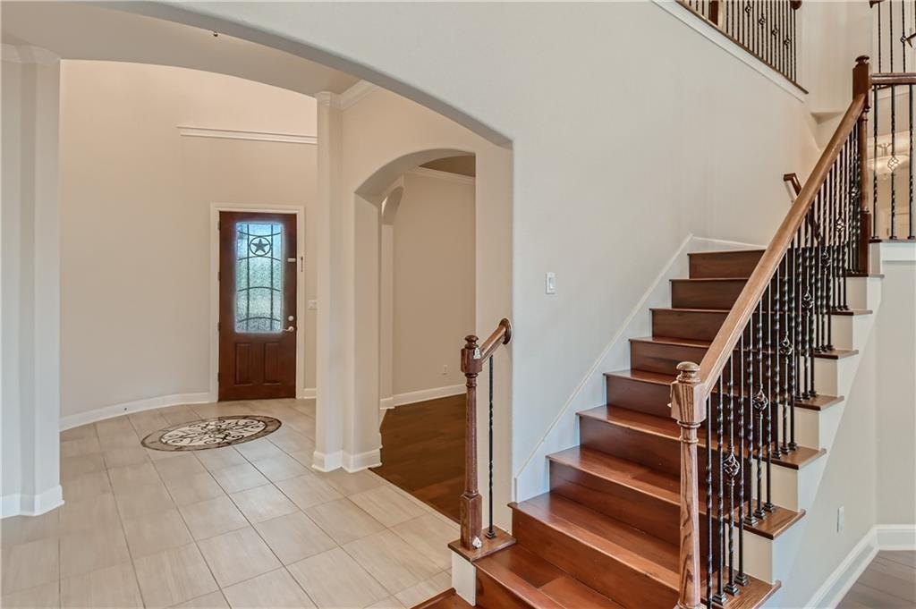 3822 Remington Road Cedar Park, TX 78613 - Photo 5 of 31 a view of front door with wooden floor and stairs