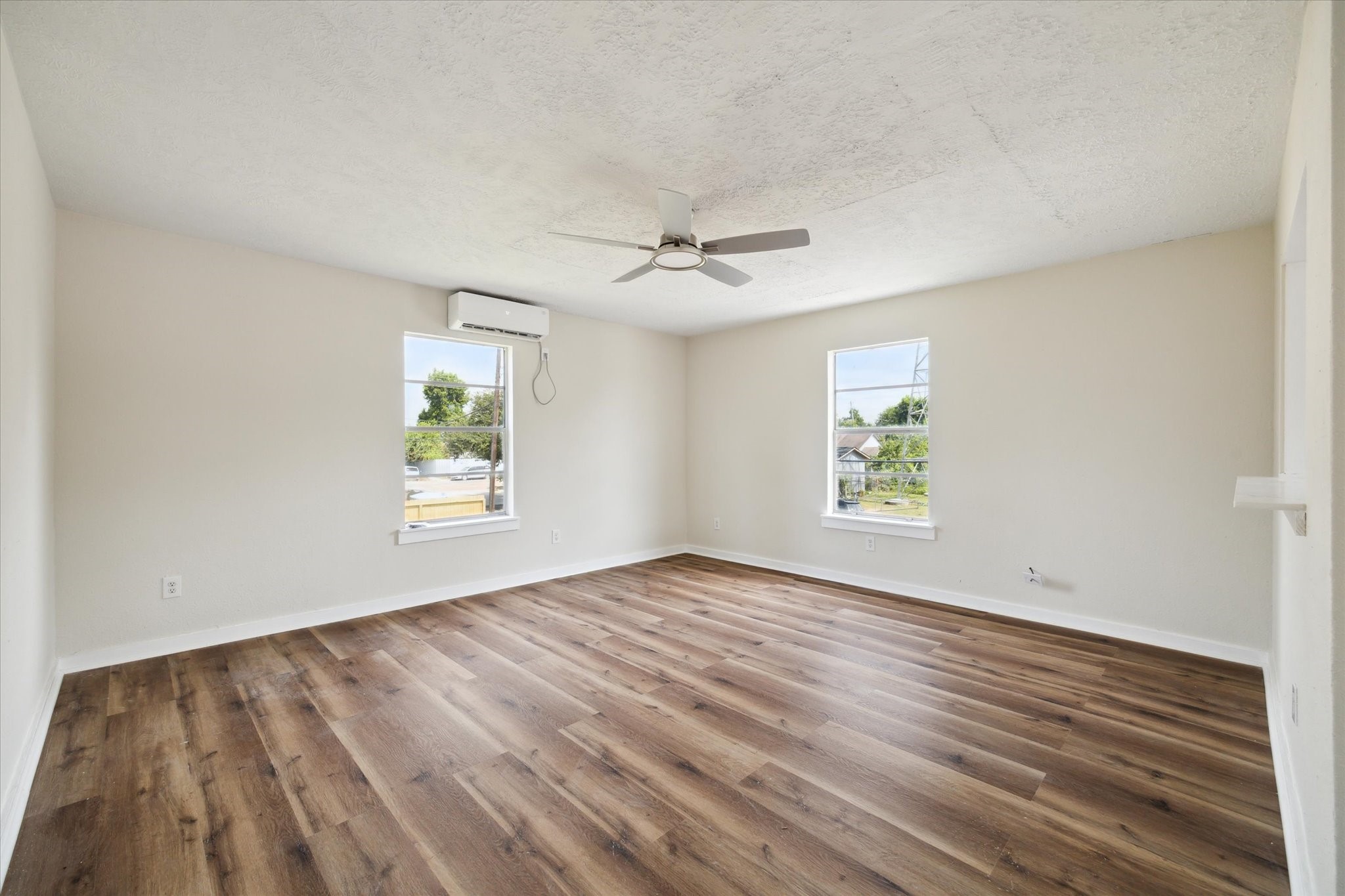 2802 Hardy Street, Unit C Houston, TX 77009 - Photo 13 of 18 wooden floor in an empty room with a window