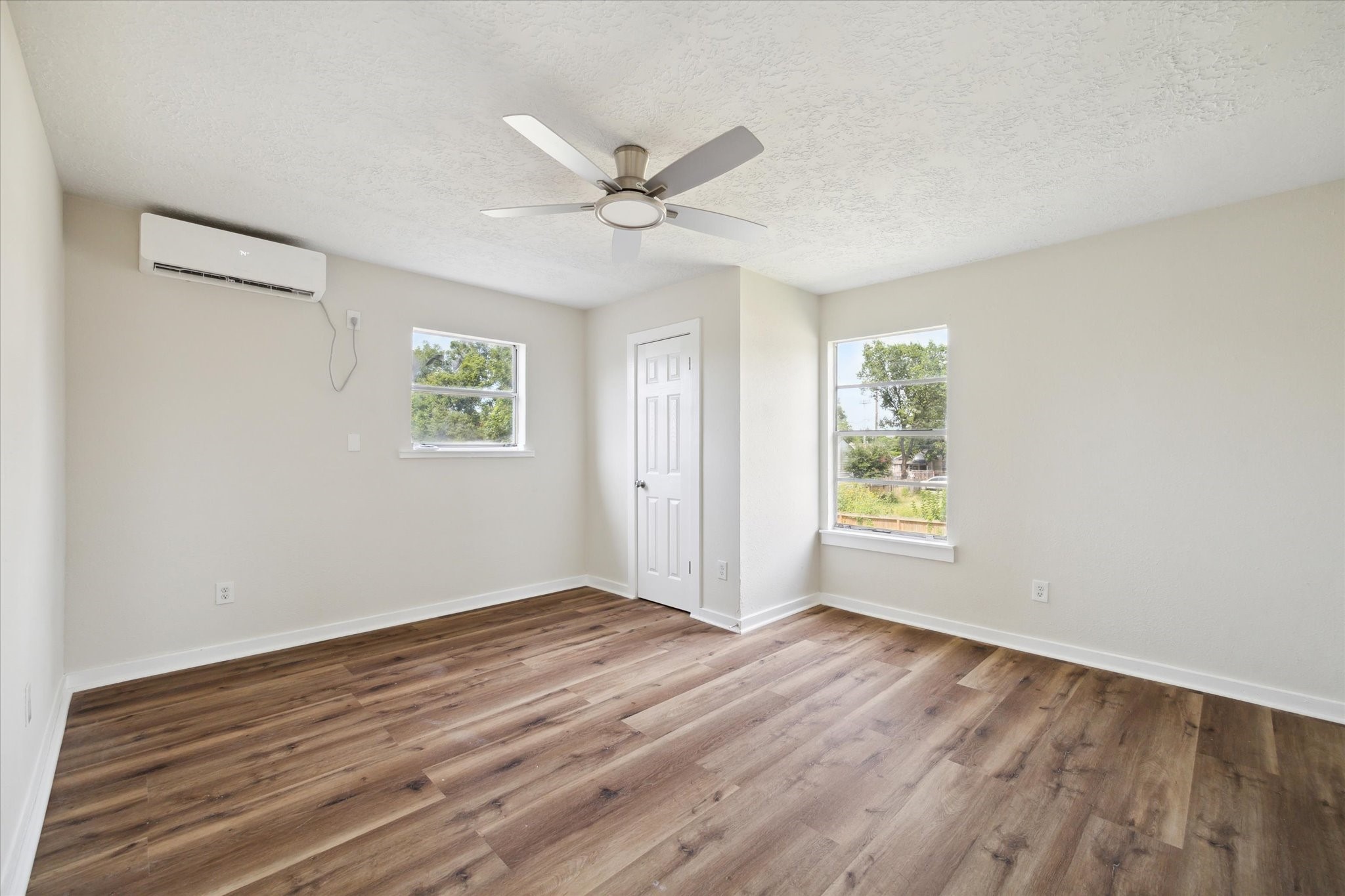 2802 Hardy Street, Unit C Houston, TX 77009 - Photo 15 of 18 a view of an empty room with wooden floor and a window
