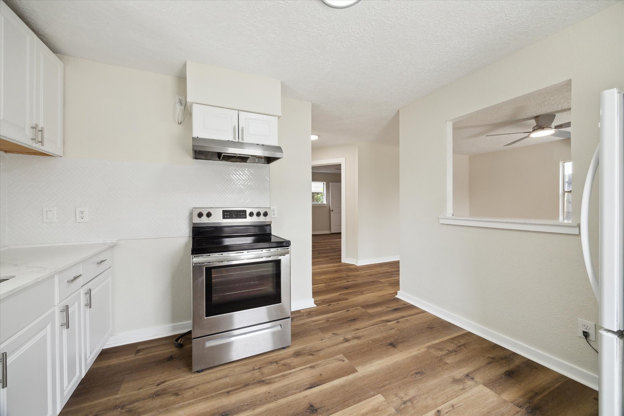 2802 Hardy Street, Unit C Houston, TX 77009 - Photo 7 of 18 a kitchen with granite countertop a stove and a sink