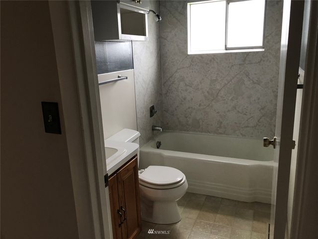 a bathroom with a toilet and a tub