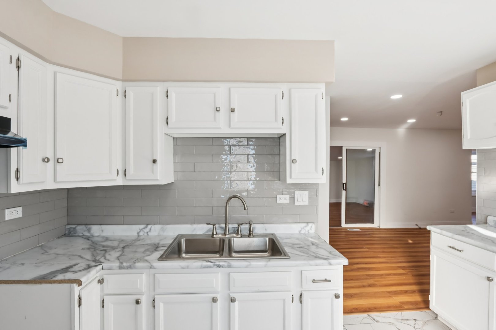 26814 North Genesee Street Wauconda, IL 60084 - Photo 11 of 34 a kitchen with granite countertop white cabinets and a sink