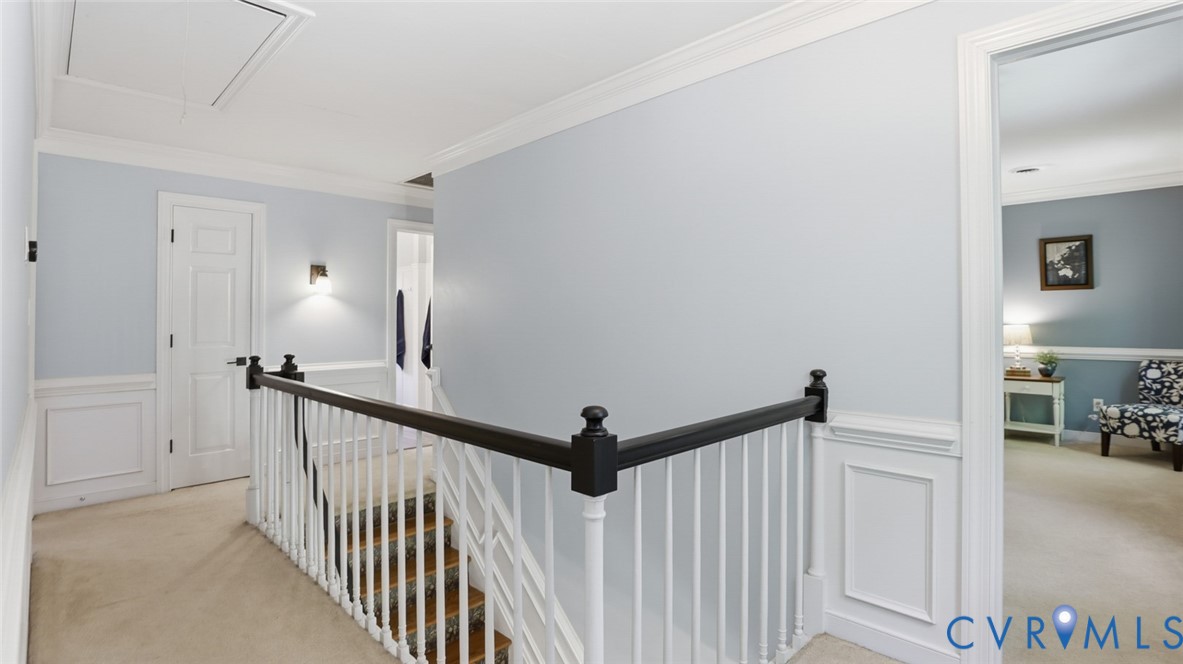 10716 Chalkley Road Richmond, VA 23237 - Photo 26 of 46 a view of a hallway to a livingroom with wooden floor and stairs