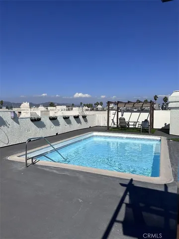 a view of swimming pool with a yard and seating space