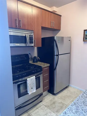 a stove top oven sitting inside of a kitchen