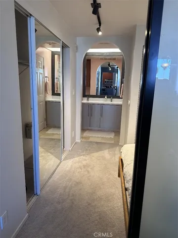 a view of a hallway view with wooden floor and entryway