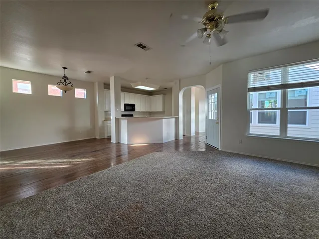 a view of empty room with a fireplace and fan
