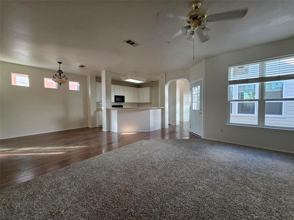 5413 Redwater Court The Colony, TX 75056 - Photo 12 of 40 a view of empty room with a fireplace and fan