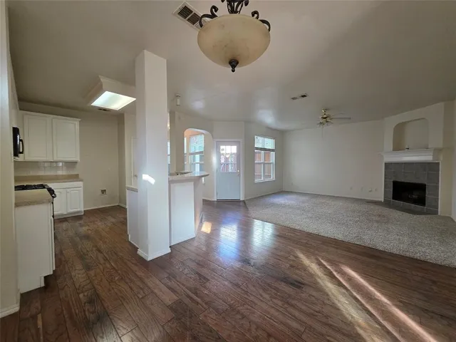 a view of a kitchen and an empty room