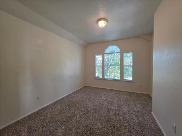 an empty room with a empty space and windows