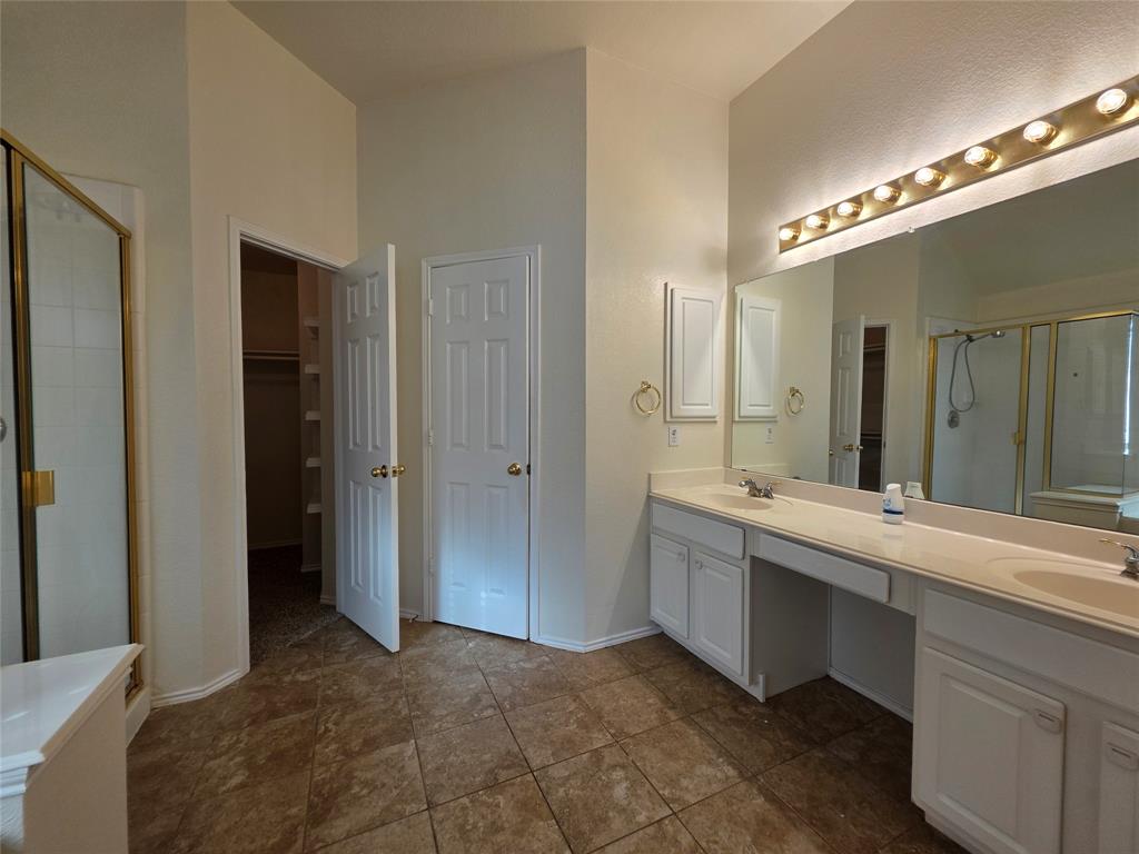 5413 Redwater Court The Colony, TX 75056 - Photo 33 of 40 a large bathroom with a double vanity sink and a mirror
