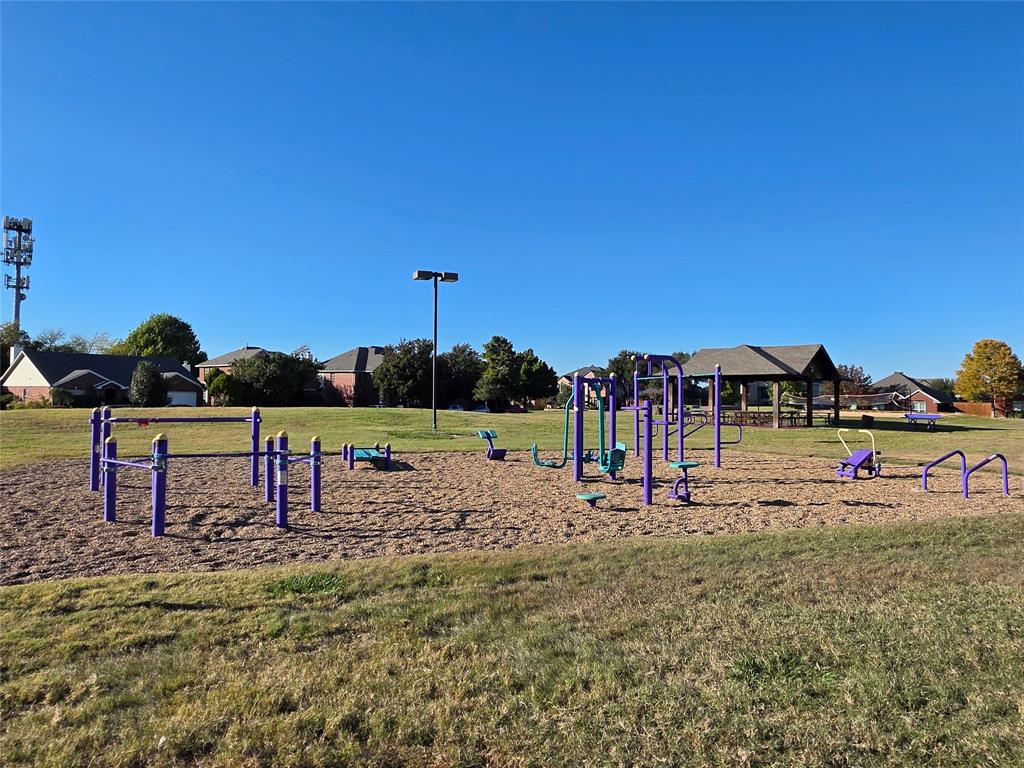 5413 Redwater Court The Colony, TX 75056 - Photo 39 of 40 a view of a park with swings and slides