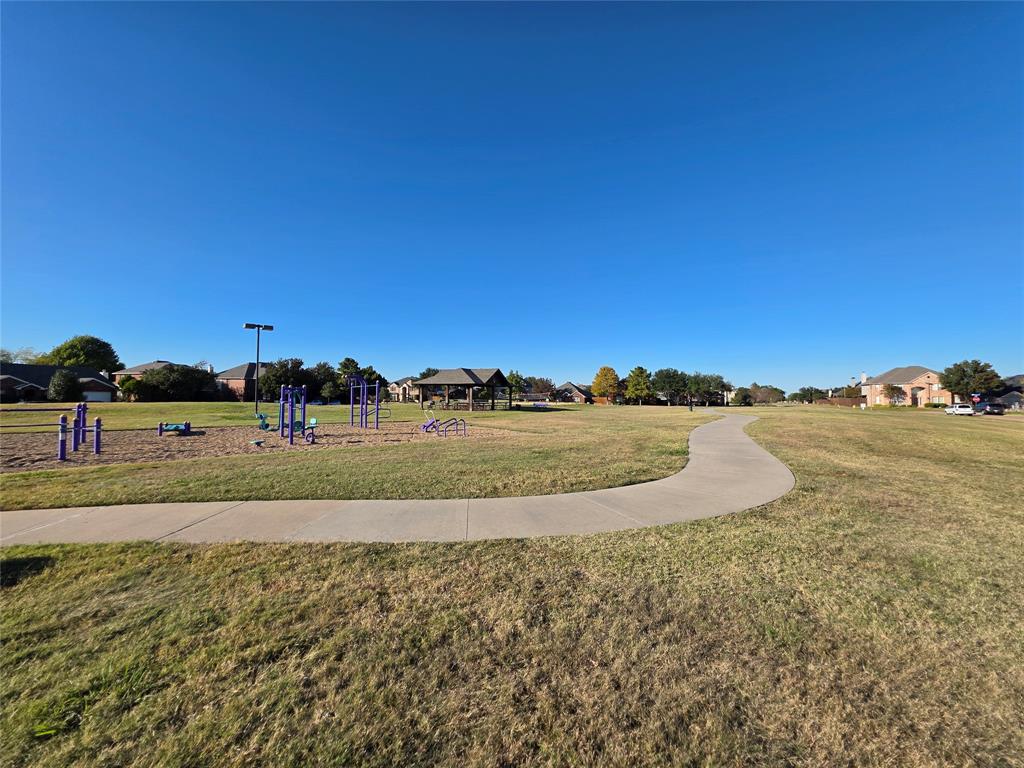 5413 Redwater Court The Colony, TX 75056 - Photo 40 of 40 a view of a road with a building in the background