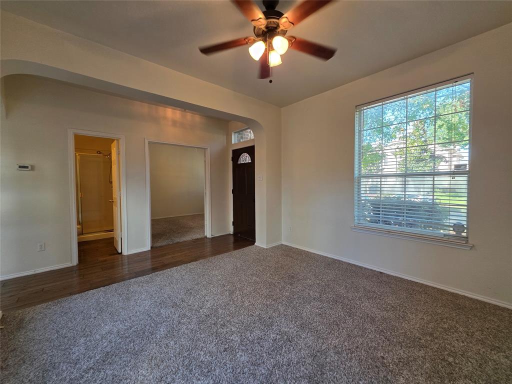 5413 Redwater Court The Colony, TX 75056 - Photo 6 of 40 a view of a big room with windows and chandelier fan