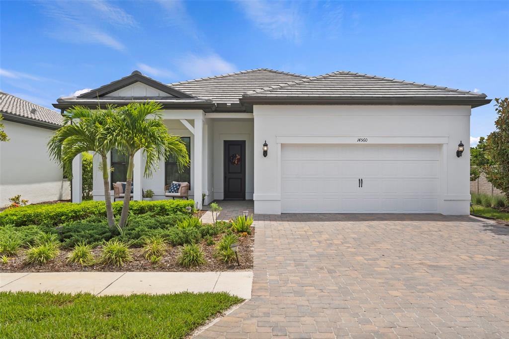 14560 Eagle Branch Drive Nokomis, FL 34275 - Photo 1 of 65 a front view of a house with garden