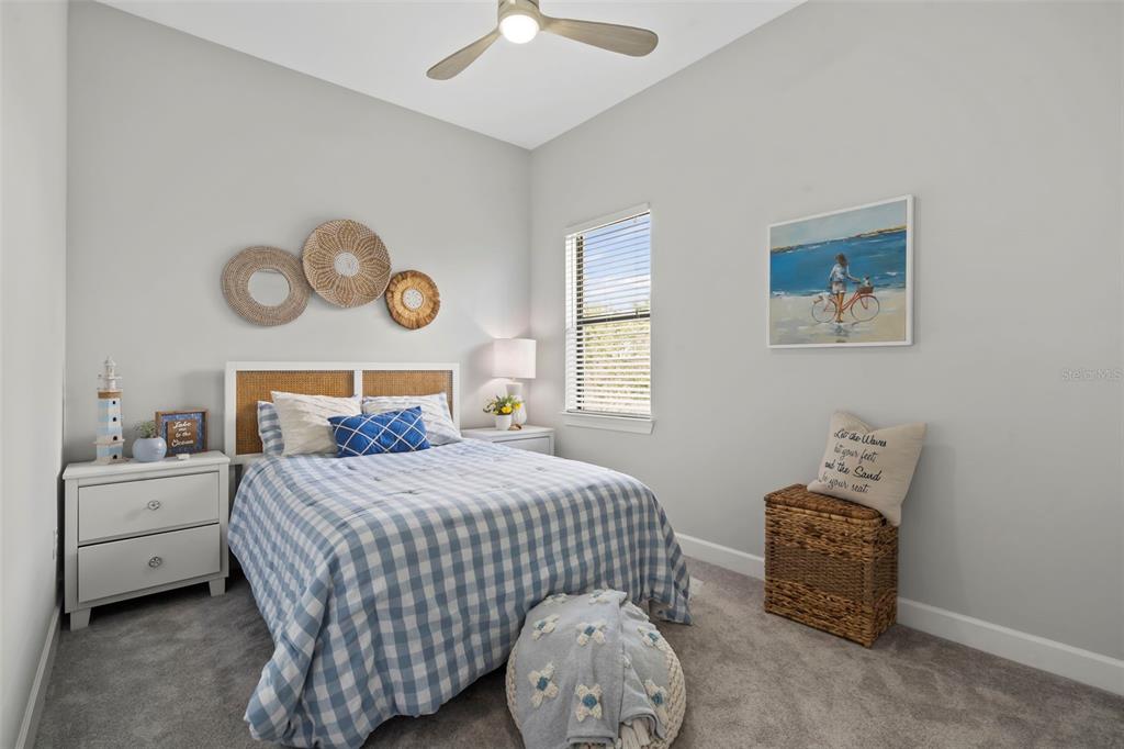 14560 Eagle Branch Drive Nokomis, FL 34275 - Photo 11 of 65 a bedroom with a bed and a lamp on dresser