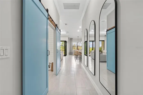 a kitchen with stainless steel appliances kitchen island granite countertop a sink a stove and white cabinets