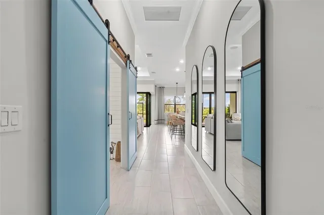 a kitchen with stainless steel appliances kitchen island granite countertop a sink a stove and white cabinets