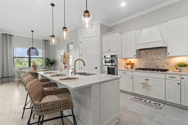 a living room with furniture and kitchen view