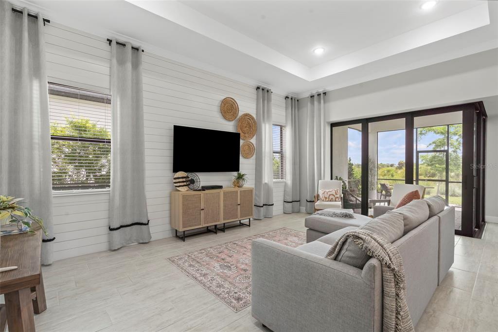 14560 Eagle Branch Drive Nokomis, FL 34275 - Photo 26 of 65 a living room with furniture and a flat screen tv