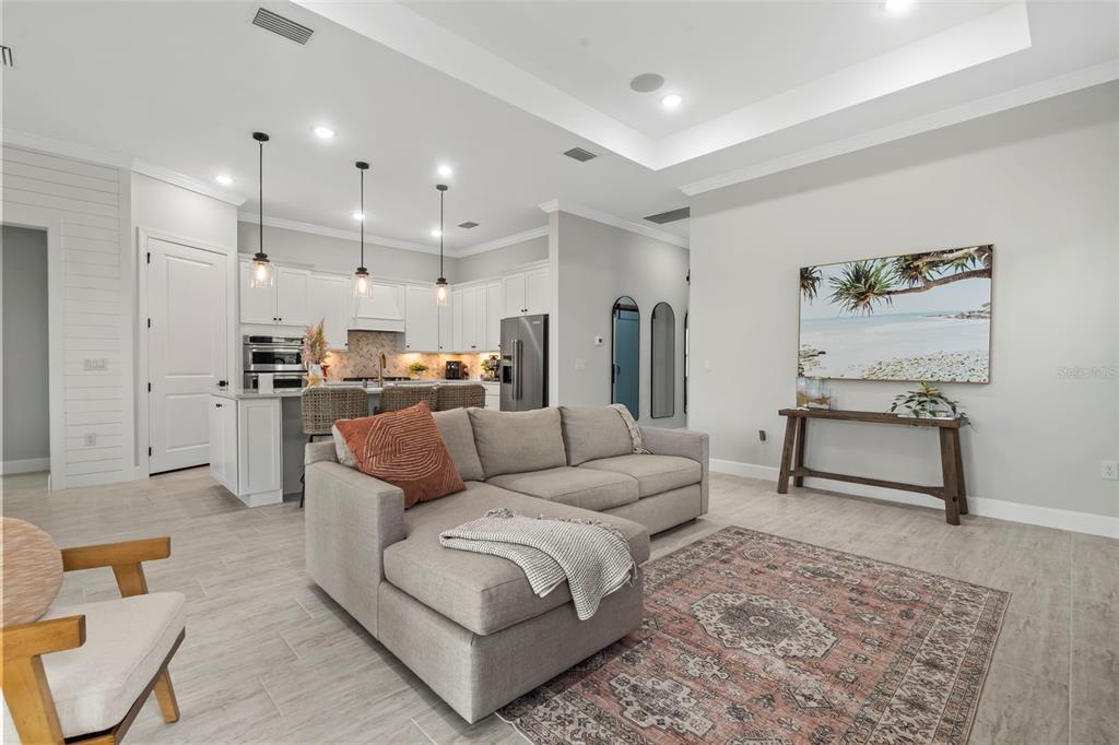 14560 Eagle Branch Drive Nokomis, FL 34275 - Photo 28 of 65 a living room with furniture and kitchen view