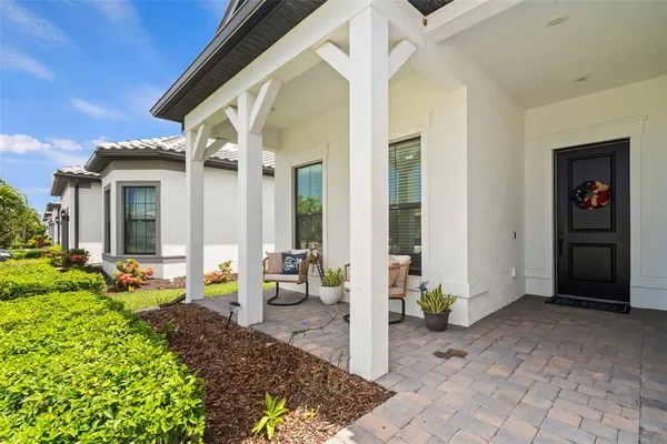 a view of a patio with table and chairs and potted plants